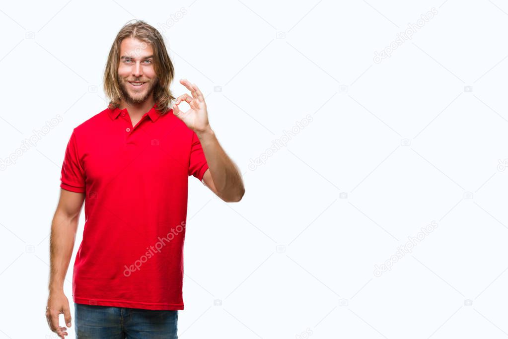 Young handsome man with long hair over isolated background smiling positive doing ok sign with hand and fingers. Successful expression.