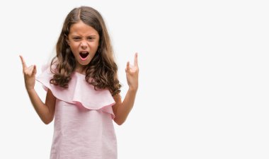 Esmer İspanyol kız deli ifade rock simge elle yapıyor ile pembe elbise bağırarak giyiyor. Müzik yıldızı. Ağır kavramı.