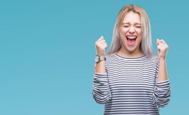 Sarışın genç kadın izole arka kolları olan başarı için heyecan üzerinde zafer kutluyor gülümseyen kaldırdı. Kazanan kavramı.