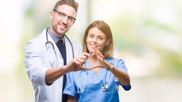 Young Couple Doctor Surgeon Isolated Background Smiling Love Showing Heart — Stock Photo, Image