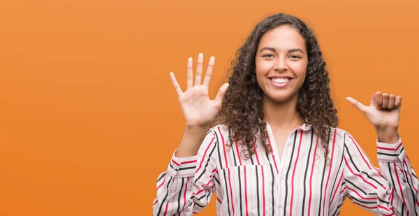 Beautiful young hispanic woman showing and pointing up with fingers number six while smiling confident and happy.