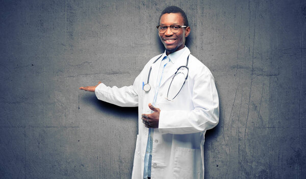 Young black doctor, medical professional confident and happy with a big natural smile inviting to enter