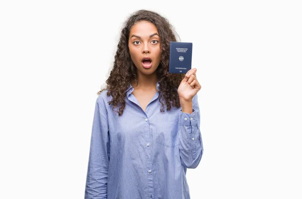 Young Hispanic Woman Holding Passport Germany Scared Shock Surprise Face — Stock Photo, Image