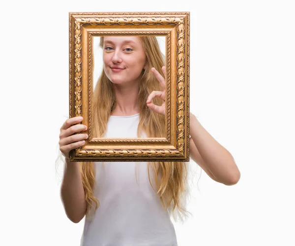 Blonde Teenager Woman Holding Vintage Frame Art Doing Sign Fingers — Stock Photo, Image