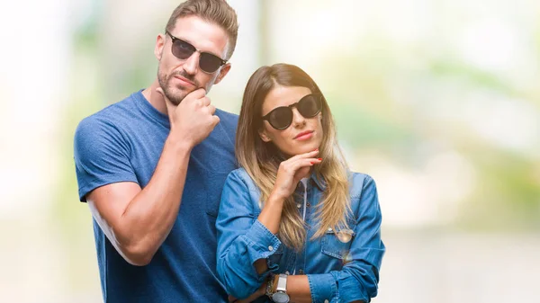 Young Couple Love Wearing Sunglasses Isolated Background Hand Chin Thinking — Stock Photo, Image