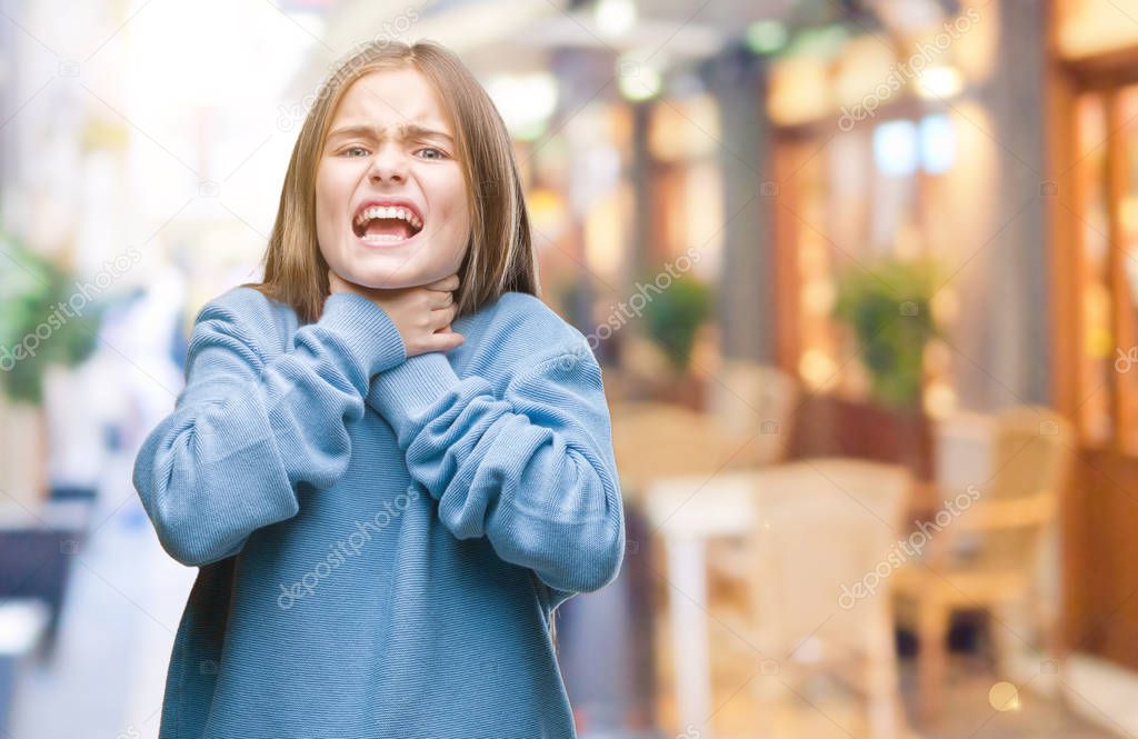Young beautiful girl wearing winter sweater over isolated background shouting and suffocate because painful strangle. Health problem. Asphyxiate and suicide concept.