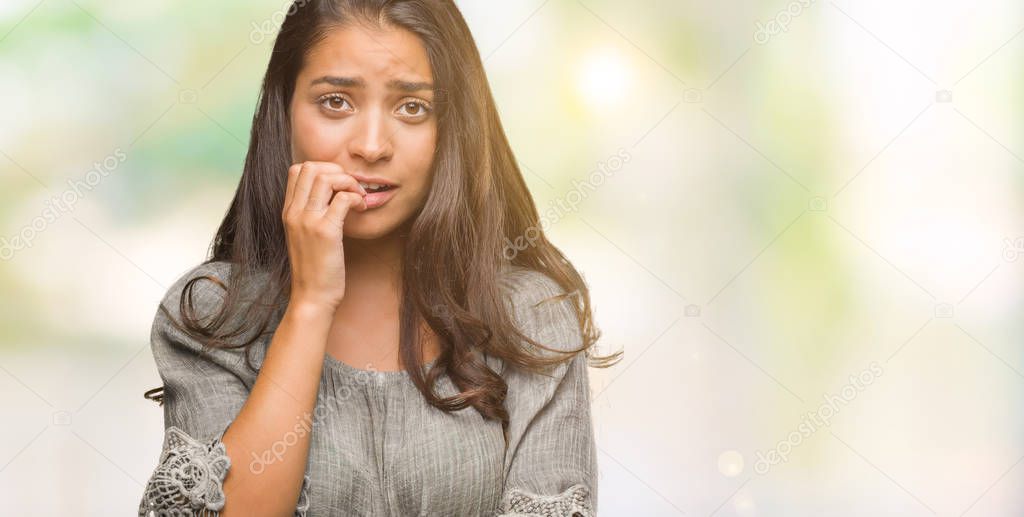 Young beautiful arab woman over isolated background looking stressed and nervous with hands on mouth biting nails. Anxiety problem.