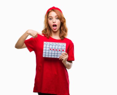 İzole arka plan adet takvim sürpriz yüz işaret parmağı kendisine tutan genç güzel kadın