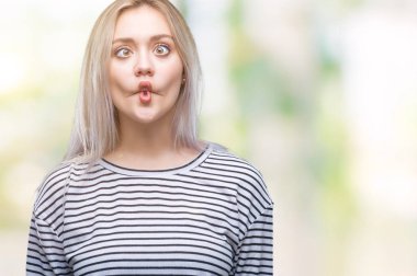 Sarışın genç kadın izole arka plan yapma balık yüzüne dudaklı, çılgın ve komik bir jest. Komik ifade.