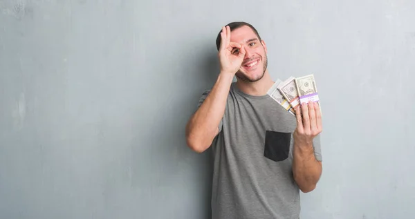 Young Caucasian Man Grey Grunge Wall Holding Bunch Money Happy — Stock Photo, Image