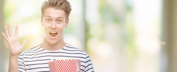 Young Handsome Blond Man Eating Popcorn Very Happy Excited Winner — Stock Photo, Image