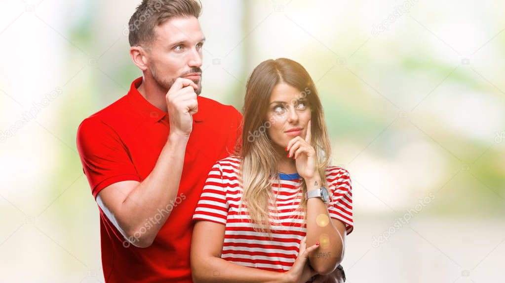 Young couple in love over isolated background with hand on chin thinking about question, pensive expression. Smiling with thoughtful face. Doubt concept.