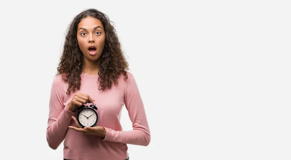Young Hispanic Woman Holding Alarm Clock Scared Shock Surprise Face — Stock Photo, Image