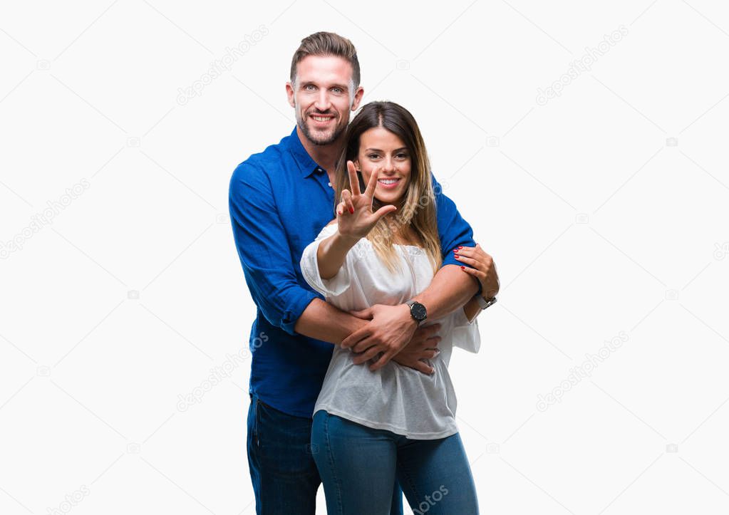 Young couple in love over isolated background showing and pointing up with fingers number three while smiling confident and happy.