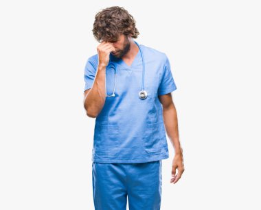 İzole arka burun ve göz yorgunluğu ve baş ağrısı duygu sürtünme yorgun yakışıklı İspanyol cerrah doktor adam. Stres ve hayal kırıklığı kavramı.