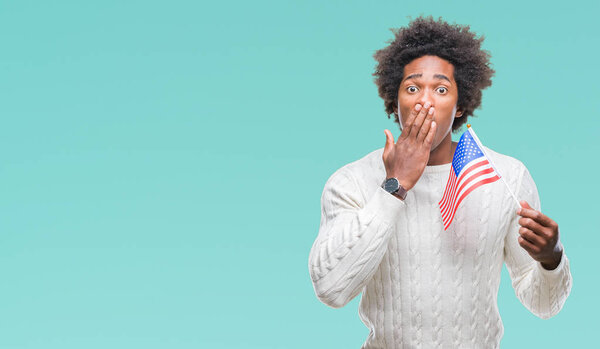 Afro american man flag of United States of America over isolated background cover mouth with hand shocked with shame for mistake, expression of fear, scared in silence, secret concept