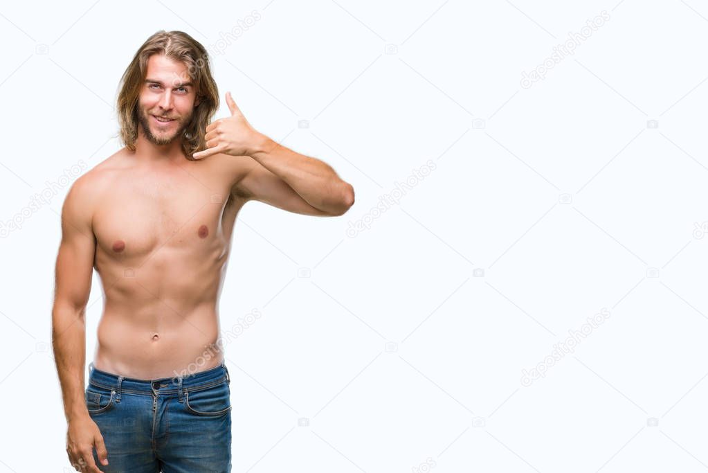 Young handsome shirtless man with long hair showing sexy body over isolated background smiling doing phone gesture with hand and fingers like talking on the telephone. Communicating concepts.