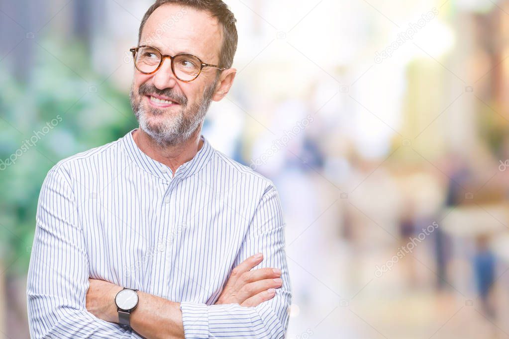 Middle age hoary senior man wearing glasses over isolated background smiling looking side and staring away thinking.