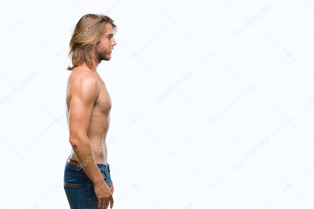 Young handsome shirtless man with long hair showing sexy body over isolated background looking to side, relax profile pose with natural face with confident smile.