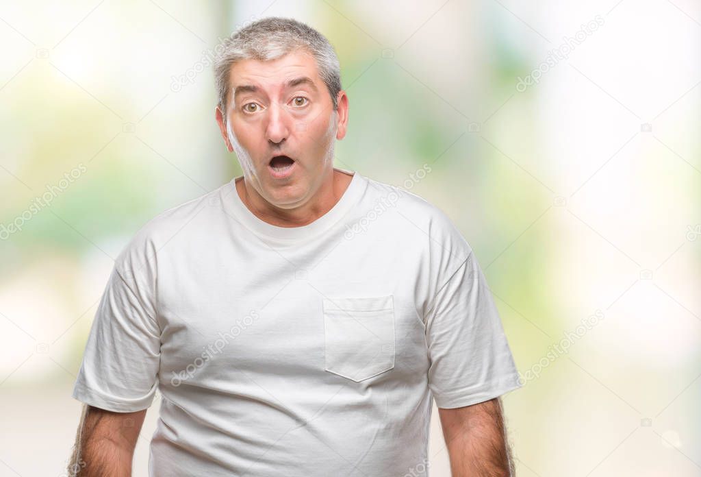 Handsome senior man over isolated background afraid and shocked with surprise expression, fear and excited face.