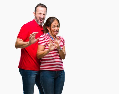 Orta yaş İspanyol çift izole arka plan üzerinde aşık tiksinti ifadesi, memnun ve korkulu tiksinti yüz yapıyorsun çünkü nefret tepki. Elleriyle kaldırdı. Sinir bozucu kavramı.