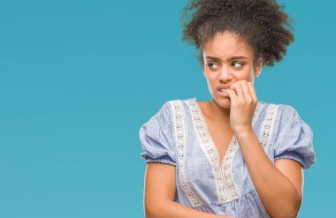 Stresli ve gergin ile eller tırnak ısırma dudaklarından seyir izole arka plan üzerinde genç afro Amerikalı kadın. Anksiyete sorunu.