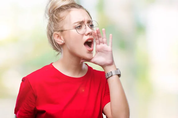 年轻的金发女郎戴着眼镜 在孤立的背景下大声喊叫 一边用手在嘴上尖叫 沟通理念 — 图库照片