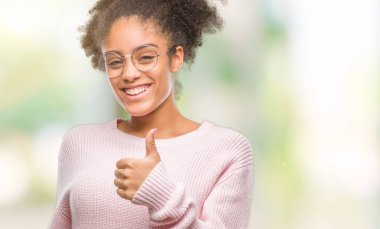 Hareketi el ile mutlu yaşasın yapıyor izole arka plan üzerinde gözlük takan genç afro Amerikalı kadın. Kameraya bakarak başarı gösteren ile ifade onaylama.
