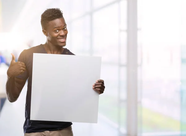 Young African American Man Holding Banner Happy Big Smile Doing — Stock Photo, Image