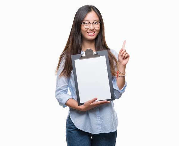 Young Asian Business Woman Holding Clipboard Isolated Background Surprised Idea — Stock Photo, Image