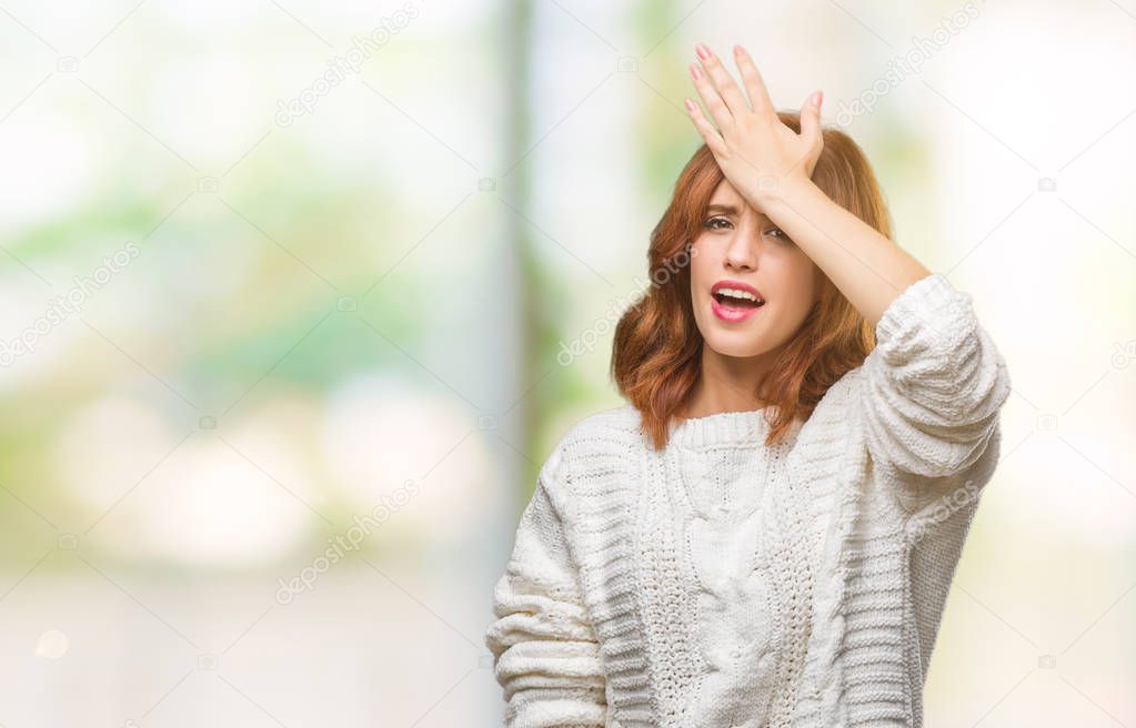 Young beautiful woman over isolated background wearing winter sweater surprised with hand on head for mistake, remember error. Forgot, bad memory concept.
