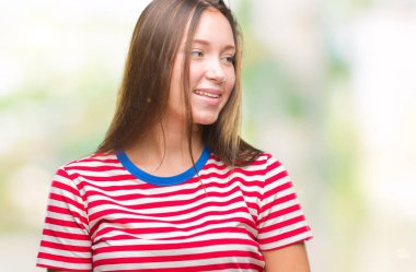 Genç beyaz güzel kadın uzak tarafına yüzünde, doğal ifade gülümseme ile seyir izole arka plan yüzünden. Kendine güvenen gülüyor.