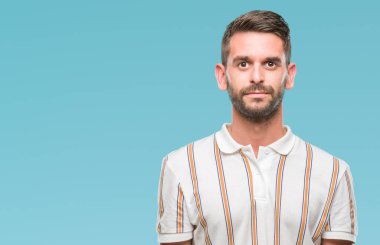 Yakışıklı delikanlı yüzünde ciddi bir ifade ile izole arka plan üzerinde. Basit ve doğal kameraya bakıyor.