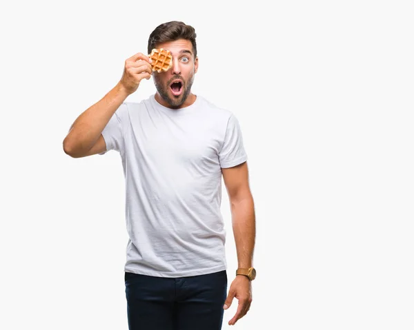 Young Handsome Man Eating Sweet Waffle Isolated Background Scared Shock — Stock Photo, Image