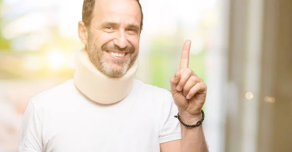 Injured Senior Man Using Neck Brace Pointing Away Side Finger — Stock Photo, Image