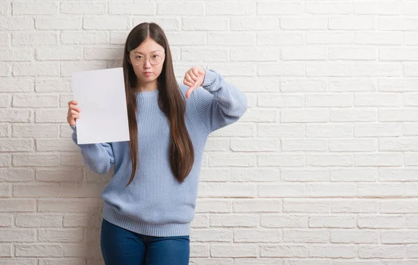 Young Chinese Woman Brick Wall Holding Blank Paper Angry Face — Stock Photo, Image