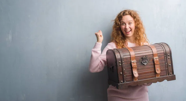 Young Redhead Woman Holding Vintage Chest Screaming Proud Celebrating Victory — Stock Photo, Image