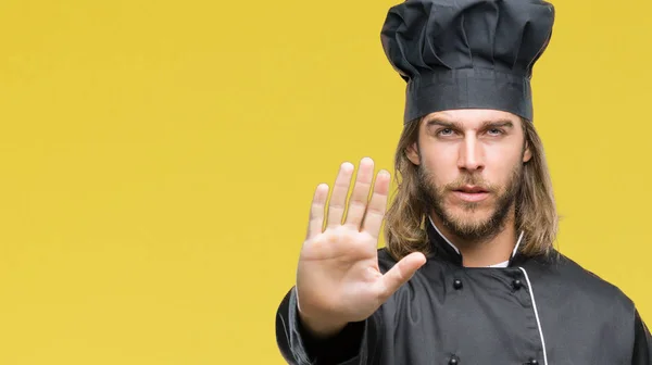 Young handsome cook man with long hair over isolated background doing stop sing with palm of the hand. Warning expression with negative and serious gesture on the face.