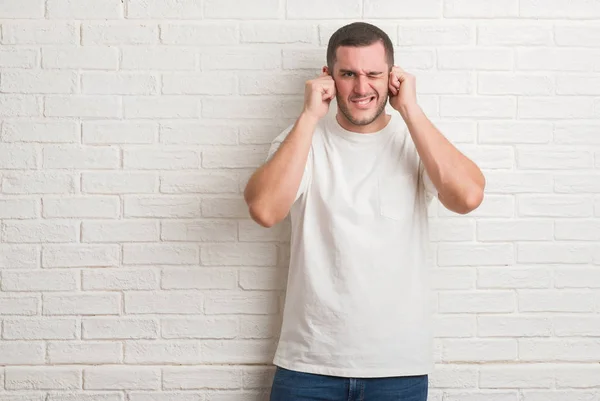 Young Caucasian Man Standing White Brick Wall Covering Ears Fingers — Stock Photo, Image