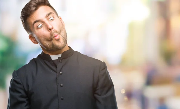 Joven Sacerdote Cristiano Católico Sobre Fondo Aislado Haciendo Cara Pez —  Fotos de Stock