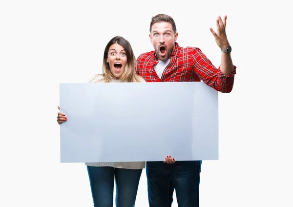 Young Couple Together Holding Blank Banner Isolated Background Very Happy — Stock Photo, Image