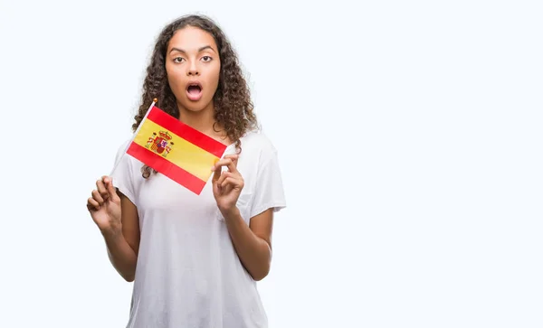 Young Hispanic Woman Holding Flag Spain Scared Shock Surprise Face — Stock Photo, Image