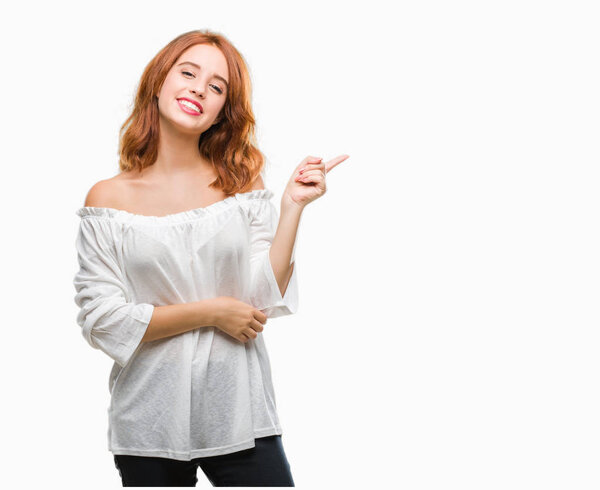 Young beautiful woman over isolated background with a big smile on face, pointing with hand and finger to the side looking at the camera.