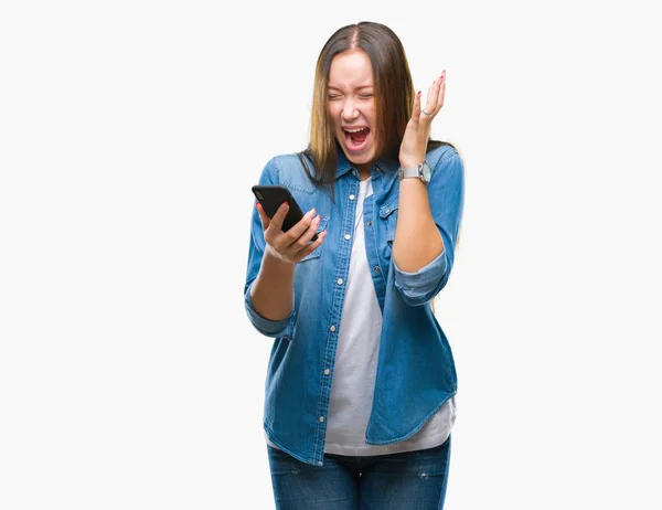年轻美丽的白人妇女短信发送消息使用智能手机在孤立的背景非常高兴和兴奋 赢家表达庆祝胜利尖叫与大微笑和举手 — 图库照片