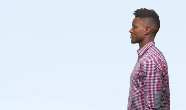 İzole arka tarafına, arayan genç Afro-Amerikan adam sakin ol kendine güvenen gülümseme ile doğal yüz pozuyla profili.