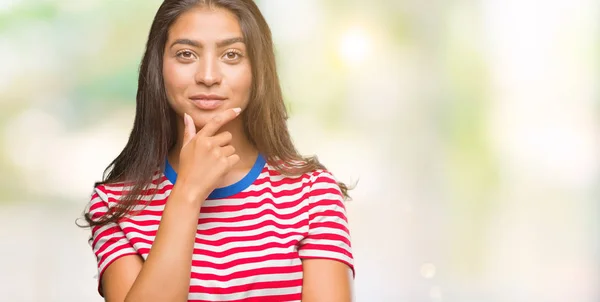 Young beautiful arab woman over isolated background looking confident at the camera with smile with crossed arms and hand raised on chin. Thinking positive.