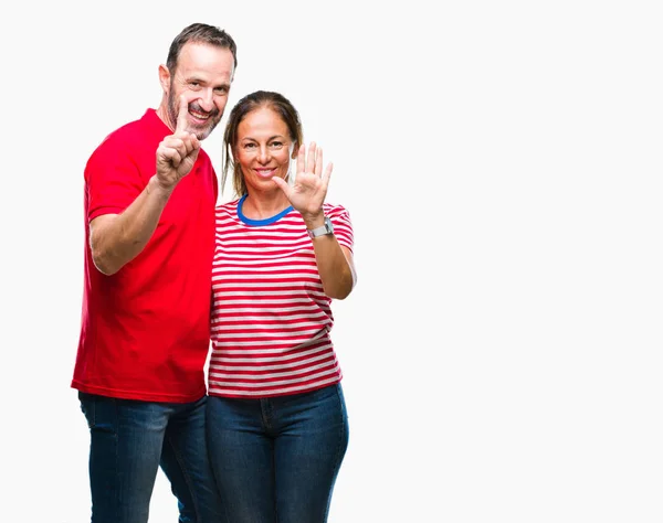 中年拉美裔夫妇在爱在孤立的背景显示和指向手指六 而微笑着自信和快乐 — 图库照片