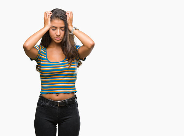 Young beautiful arab woman over isolated background suffering from headache desperate and stressed because pain and migraine. Hands on head.