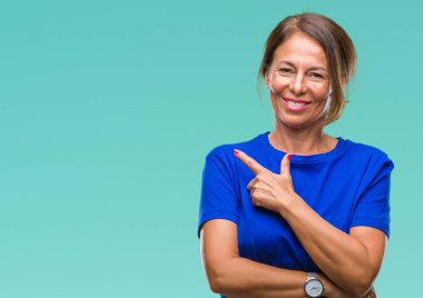 Orta yaş izole arka neşeli bir gülümseme ile el ve parmak kadar kameraya bakarak yüzündeki mutlu ve doğal ifade ile yan ile işaret yüz üzerinden İspanyol kadın kıdemli.