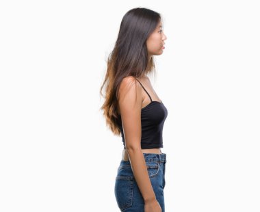 Genç Asyalı kadın izole arka tarafına, seyir üzerinde dinlenmek doğal yüz emin gülümseme ile pozuyla profili.